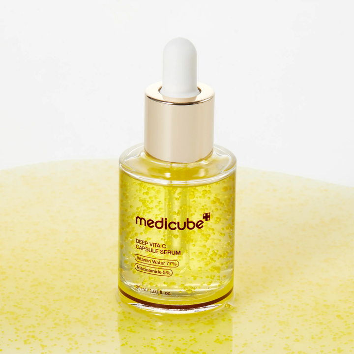 Medicube Deep Vita C Capsule Serum bottle on yellow background
